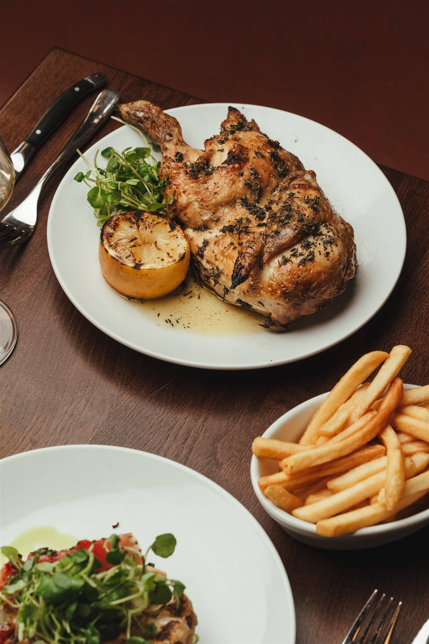 Half roast chicken with charred lemon and skin-on fries