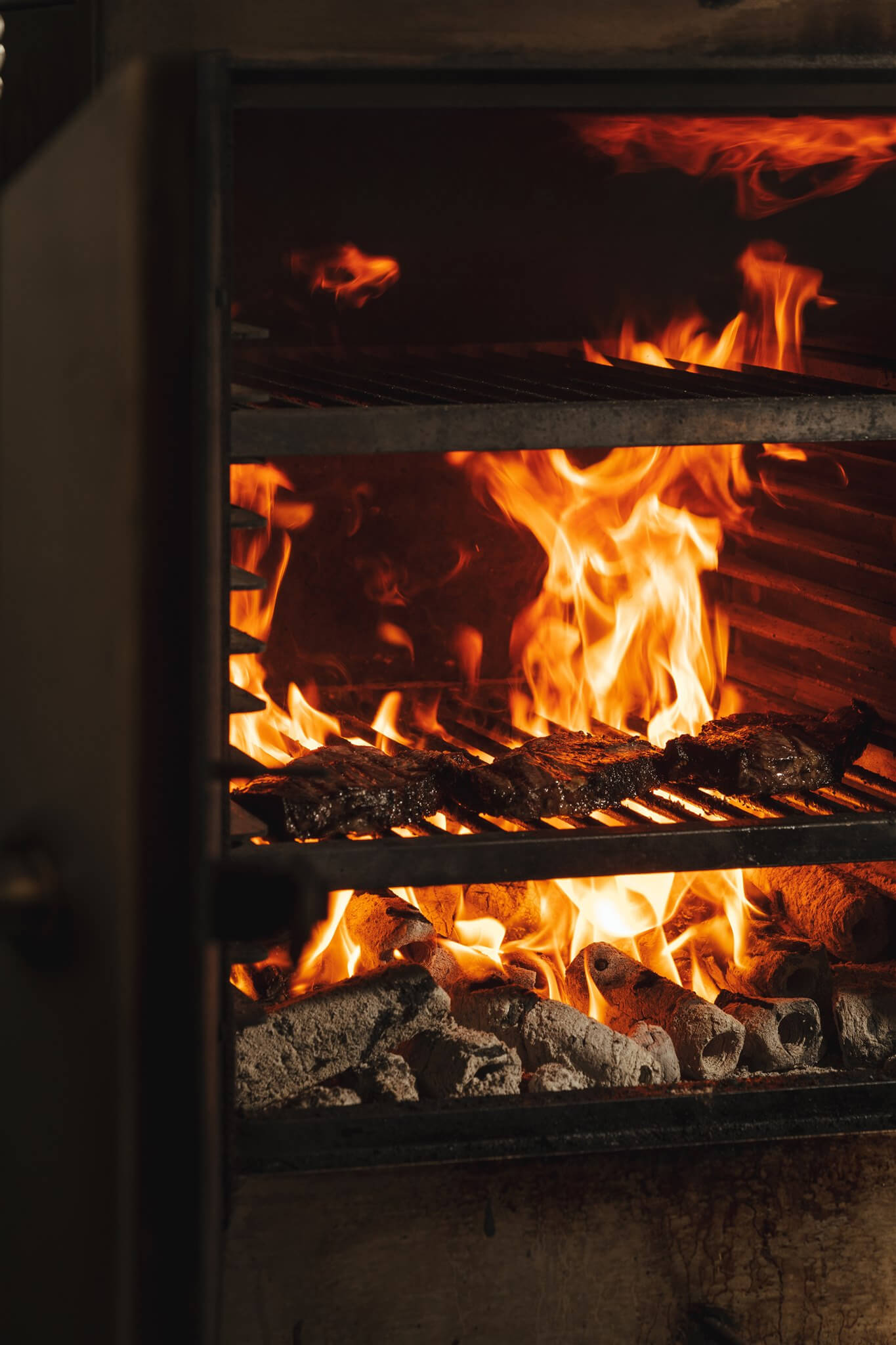 Steaks cooking over the charcoal grill