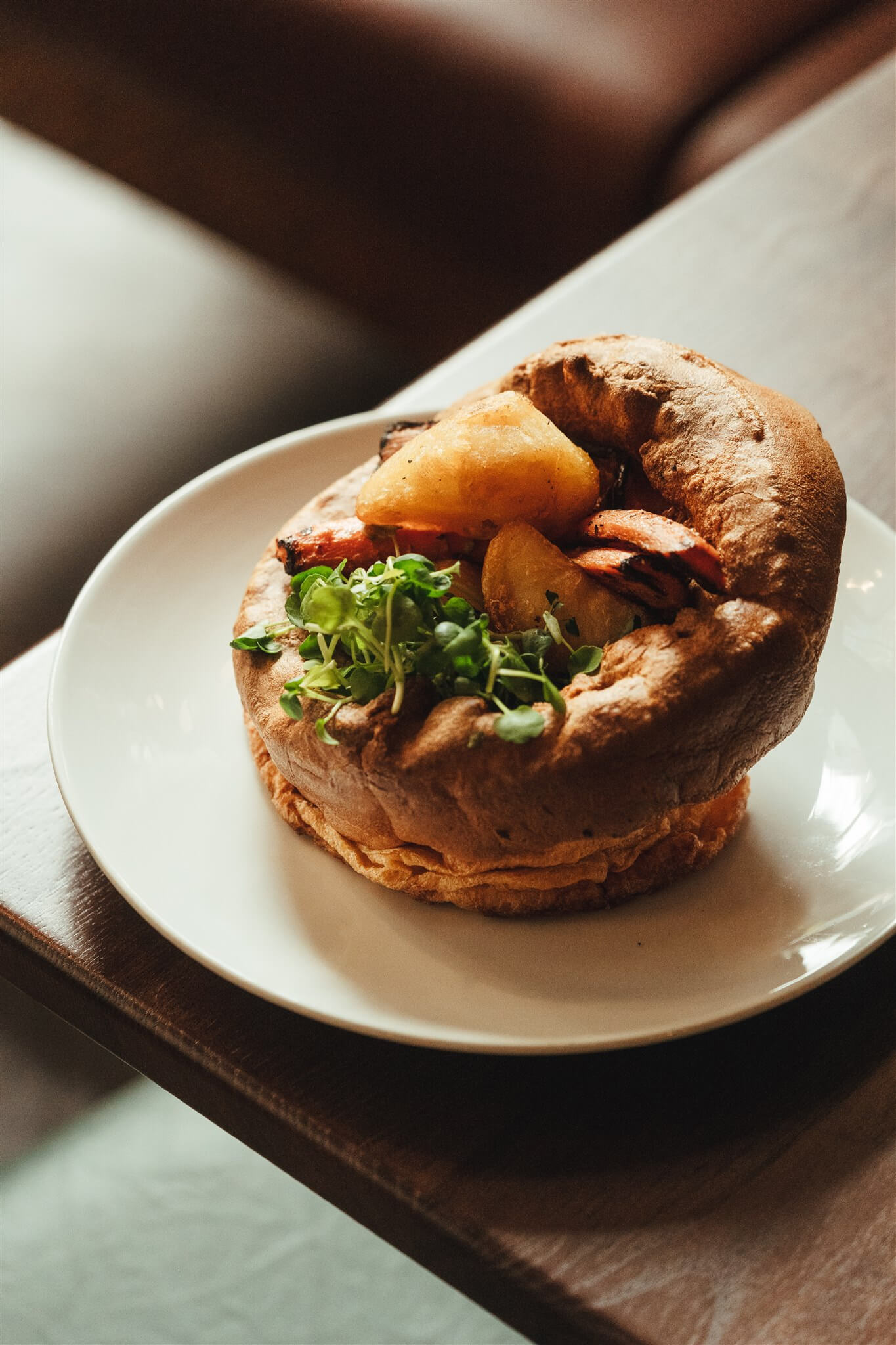 A crisp Yorkshire pudding piled with roast potatoes and carrots